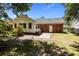 Private backyard featuring a brick patio, a white door and a well-maintained lawn with mature trees providing shade at 133 Bramwell Dr, Summerville, SC 29485