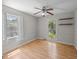 Bright bedroom featuring wood floors, ceiling fan, and large windows providing natural light at 133 Bramwell Dr, Summerville, SC 29485