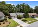 Well-maintained brick home with an attached two-car garage, mature trees, and a verdant lawn at 133 Bramwell Dr, Summerville, SC 29485