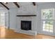 Living room showcasing a white brick fireplace, hardwood floors, and a window at 133 Bramwell Dr, Summerville, SC 29485