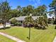 Charming single-story home with a well-manicured lawn, mature palm trees, and inviting front porch at 133 Bramwell Dr, Summerville, SC 29485