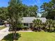 Beautiful single-story home featuring a well-kept lawn, brick accents, and lush landscaping at 133 Bramwell Dr, Summerville, SC 29485