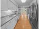 Well-lit kitchen with white cabinets, hardwood floors, and stainless steel appliances at 133 Bramwell Dr, Summerville, SC 29485
