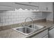 Stainless steel sink with subway tile backsplash and granite countertops at 133 Bramwell Dr, Summerville, SC 29485