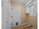 Cozy laundry room featuring white cabinets and walls, complementing the light tile flooring at 133 Bramwell Dr, Summerville, SC 29485
