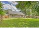Sprawling backyard with mature trees, a green lawn, patio and a privacy fence at 138 Wainwright Manor, Summerville, SC 29485
