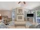 Comfortable living room features vaulted ceilings, painted fireplace with hearth, and access to the backyard at 138 Wainwright Manor, Summerville, SC 29485