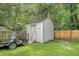 Backyard shed with a door, set amongst mature trees and greenery at 138 Wainwright Manor, Summerville, SC 29485