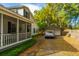 Charming home exterior with a cozy front porch, detached garage, and mature trees at 1518 Southwick Dr, Johns Island, SC 29455
