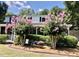Charming home featuring a bench and vibrant crepe myrtles in the beautifully landscaped front yard at 1518 Southwick Dr, Johns Island, SC 29455