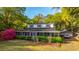 Charming two-story home with a screened porch, lush landscaping, and a detached garage on a sunny day at 1518 Southwick Dr, Johns Island, SC 29455