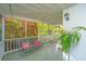 Charming screened porch featuring a swing and views of the lush garden area at 1518 Southwick Dr, Johns Island, SC 29455