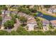 An aerial view showing houses near a pond with a fountain and treed landscaping, showcasing community appeal at 1536 Keshi Pearl Dr, Mount Pleasant, SC 29466