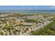 Expansive aerial shot of a neighborhood with ponds, lush trees, and distant water views at 1536 Keshi Pearl Dr, Mount Pleasant, SC 29466