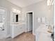 Spacious bathroom featuring double sinks, white vanities, modern fixtures, and a doorway leading to a bedroom at 1536 Keshi Pearl Dr, Mount Pleasant, SC 29466