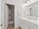 Clean bathroom with white cabinets, stone tile flooring, and shower and tub combo at 1536 Keshi Pearl Dr, Mount Pleasant, SC 29466