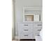 Close-up of a whitewashed dresser and mirror in a bedroom with neutral tones at 1536 Keshi Pearl Dr, Mount Pleasant, SC 29466