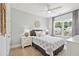 Stylish bedroom featuring a ceiling fan and a large window offering a bright and comfortable space at 1536 Keshi Pearl Dr, Mount Pleasant, SC 29466