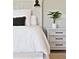 Bedroom detail with whitewashed nightstand, modern lamp, and simple decor at 1536 Keshi Pearl Dr, Mount Pleasant, SC 29466