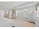 Spacious bedroom features tray ceilings, whitewashed dressers, and lots of light at 1536 Keshi Pearl Dr, Mount Pleasant, SC 29466