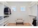 Walk-in closet featuring built-in shelving, hanging rods, and a cozy seat beneath two windows at 1536 Keshi Pearl Dr, Mount Pleasant, SC 29466
