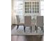 Elegant dining area features a glass-top table, stylish chairs, and a decorative china cabinet at 1536 Keshi Pearl Dr, Mount Pleasant, SC 29466