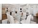 Open dining room features a glass table, seating for six, and views into the living spaces at 1536 Keshi Pearl Dr, Mount Pleasant, SC 29466