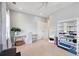 Bright exercise room features a ceiling fan, shelving, and a desk area at 1536 Keshi Pearl Dr, Mount Pleasant, SC 29466