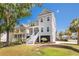 Charming gray two-story home with inviting front porch, lush landscaping and a corner lot location at 1536 Keshi Pearl Dr, Mount Pleasant, SC 29466