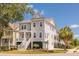 Charming gray two-story home with inviting front porch, lush landscaping and a corner lot location at 1536 Keshi Pearl Dr, Mount Pleasant, SC 29466
