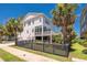 Charming two-story home with a black fenced yard, lush landscaping, and inviting curb appeal at 1536 Keshi Pearl Dr, Mount Pleasant, SC 29466