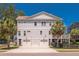 Two-story home showcasing a double garage, manicured lawn, and a welcoming entryway at 1536 Keshi Pearl Dr, Mount Pleasant, SC 29466