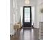 Inviting foyer with a dark wood floor, stylish lighting, and elegant decor at 1536 Keshi Pearl Dr, Mount Pleasant, SC 29466