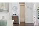 Hallway with wood floors, decorative furniture and an open doorway to a bathroom at 1536 Keshi Pearl Dr, Mount Pleasant, SC 29466