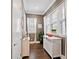 Hallway featuring natural light through windows, white trim, and decorative furniture at 1536 Keshi Pearl Dr, Mount Pleasant, SC 29466