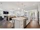 Open concept kitchen with island seating and stainless dishwasher, connected to living and dining areas at 1536 Keshi Pearl Dr, Mount Pleasant, SC 29466