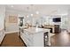 Bright, airy kitchen features an oversized island with bar stools and stainless steel appliances at 1536 Keshi Pearl Dr, Mount Pleasant, SC 29466