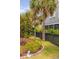 Beautiful landscaping with a green lawn, palm trees, and a decorative fence along the perimeter at 1536 Keshi Pearl Dr, Mount Pleasant, SC 29466
