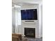 Bright living room featuring shiplap accent wall with fireplace and large screen TV at 1536 Keshi Pearl Dr, Mount Pleasant, SC 29466