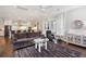 Cozy living room with hardwood floors, plush sofa, and open access to a modern kitchen at 1536 Keshi Pearl Dr, Mount Pleasant, SC 29466