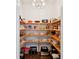 Walk-in pantry with wooden shelving, perfect for organized storage and easy access to kitchen essentials at 1536 Keshi Pearl Dr, Mount Pleasant, SC 29466