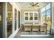 Inviting porch area featuring a dining table, ceiling fan, and large sliding glass doors at 1536 Keshi Pearl Dr, Mount Pleasant, SC 29466