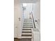 Staircase with dark wood treads, white risers, and modern decor at 1536 Keshi Pearl Dr, Mount Pleasant, SC 29466