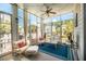 Bright and airy sunroom featuring comfortable seating, a ceiling fan, and large windows overlooking the outdoors at 1536 Keshi Pearl Dr, Mount Pleasant, SC 29466