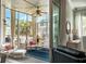 Inviting sunroom featuring ample seating, a ceiling fan, and large windows providing beautiful natural light at 1536 Keshi Pearl Dr, Mount Pleasant, SC 29466