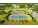 Aerial view of well-maintained tennis courts surrounded by lush landscaping and community greenery at 1536 Keshi Pearl Dr, Mount Pleasant, SC 29466
