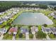 Aerial view of homes surrounding a scenic lake with a fountain feature and lush green spaces at 170 Highwoods Plantation Ave, Summerville, SC 29485