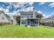 Beautiful backyard featuring a screened porch and lush green lawn at 170 Highwoods Plantation Ave, Summerville, SC 29485