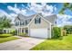 Charming two-story home featuring a well-maintained lawn, two-car garage and classic architectural details at 170 Highwoods Plantation Ave, Summerville, SC 29485
