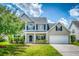 Beautiful home featuring a well-manicured lawn, two-car garage, and inviting front porch at 170 Highwoods Plantation Ave, Summerville, SC 29485